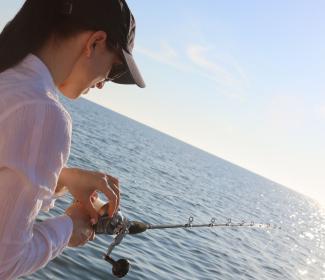 Woman offshore fishing on the Alabama Gulf Coast